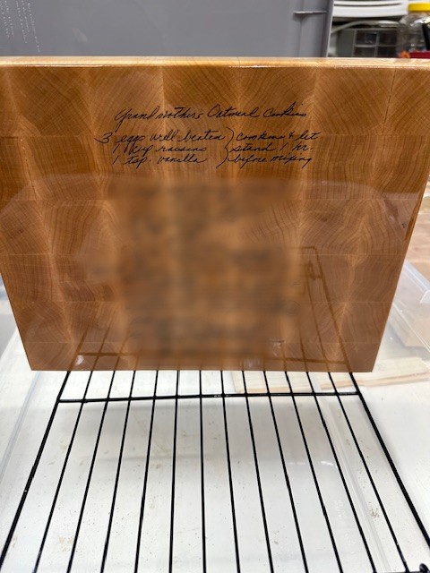 Walnut end grain cutting board with handwritten recipe.